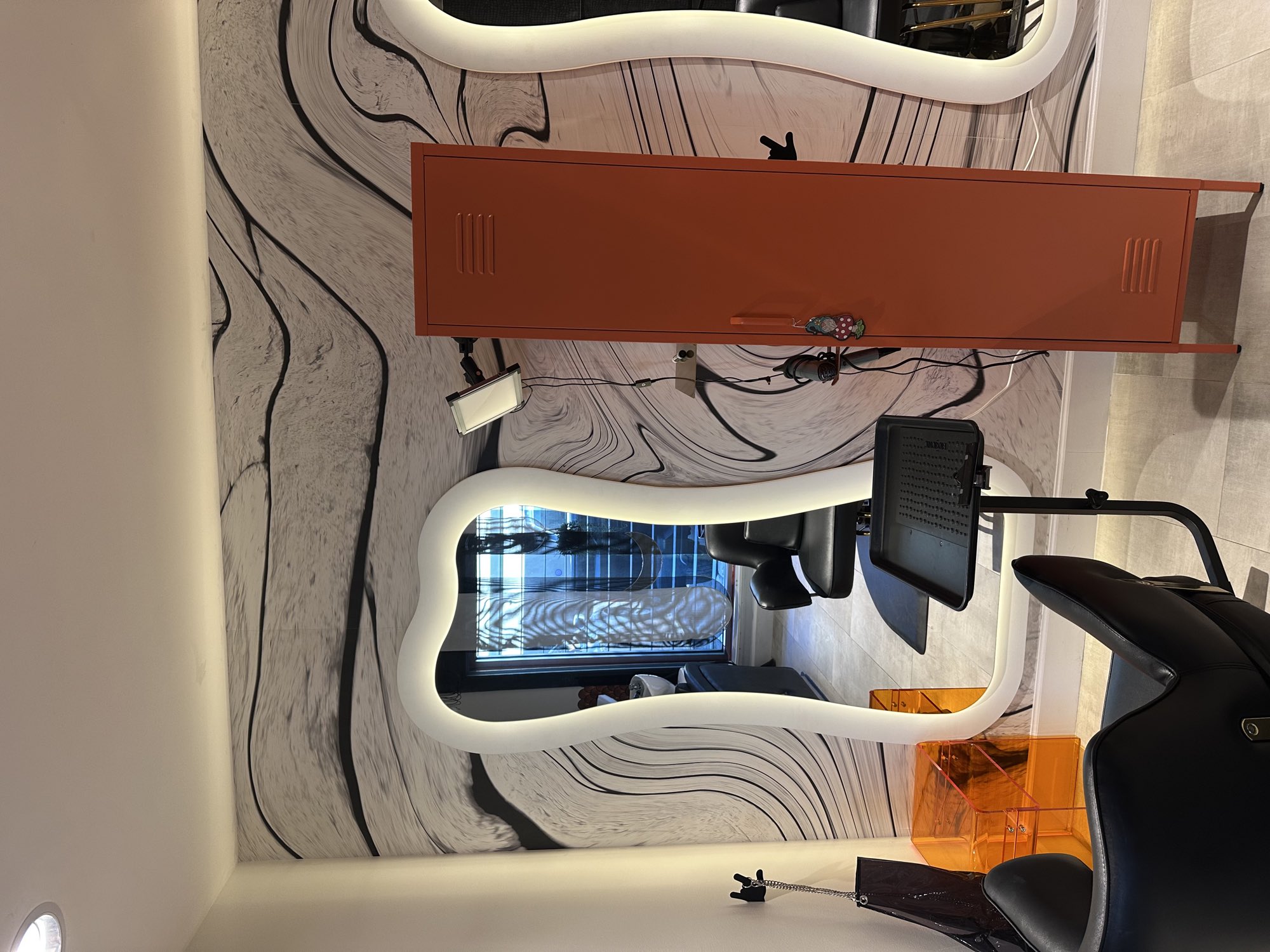 Inside Studio Deco — wave walls, orange lockers, styling chairs