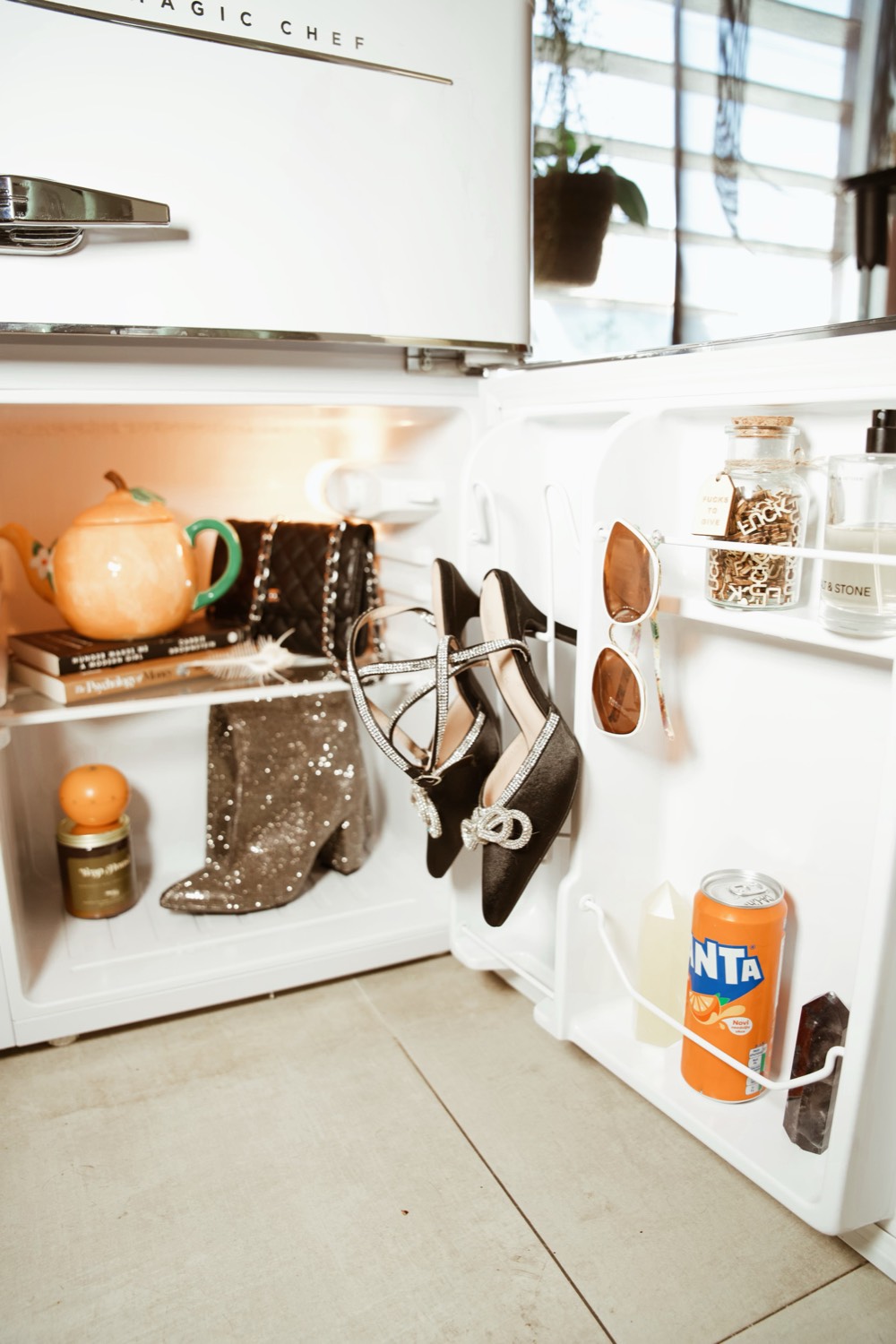 Products and boots on a lit studio shelf