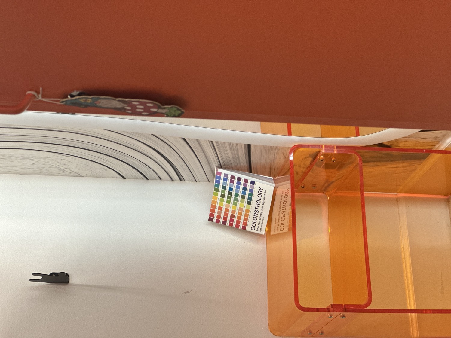 Orange acrylic and the color swatch book in the studio