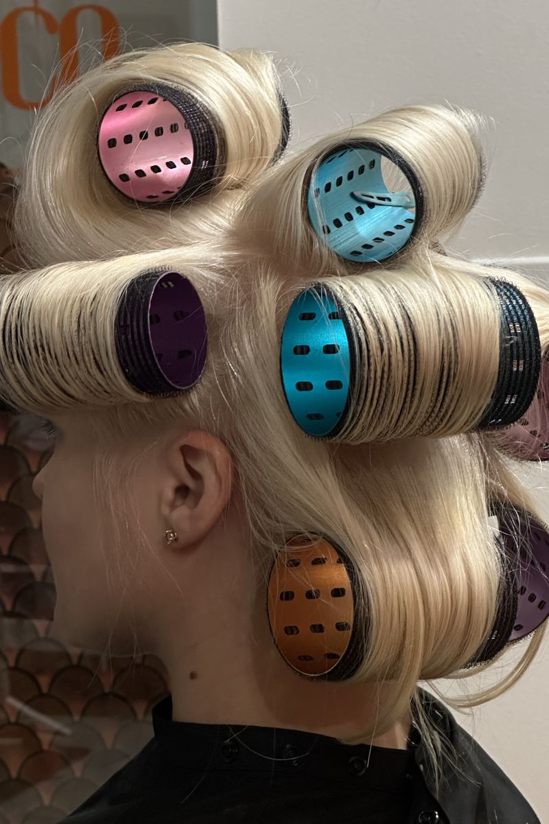 Platinum hair set in colored rollers in the studio